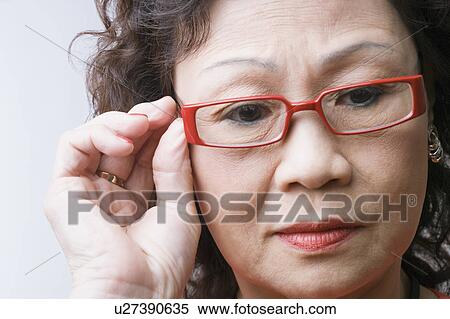 Stock Photography - Close-up of a senior woman thinking. Fotosearch