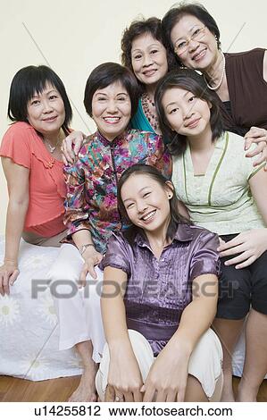 Stock Image - Portrait of a group of women posing and smiling. Fotosearch