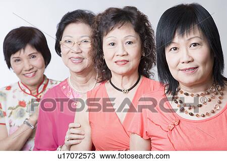 Stock Image - Portrait of three senior women and a mature woman smiling. Fotosearch