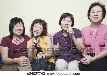 Three senior women and a mature woman singing in front of microphones View Large Photo Image Stock Image - Three senior women and a mature woman singing in front of microphones. Fotosearch