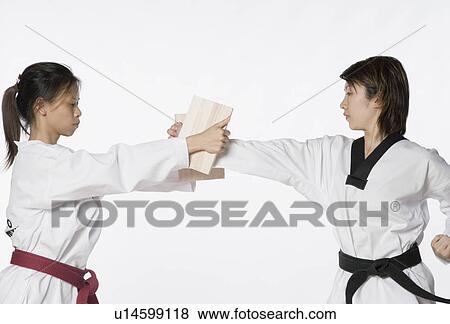 Female karate instructor teaching martial arts to a young woman View Large Photo Image Stock Photo - Female karate instructor teaching martial arts to a young woman. Fotosearch