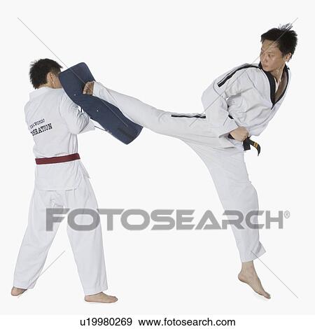 Stock Photo - Male karate instructor teaching martial arts to a young man. Fotosearch