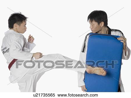 Male karate instructor teaching martial arts to a young man View Large Photo Image Stock Photography - Male karate instructor teaching martial arts to a young man. Fotosearch