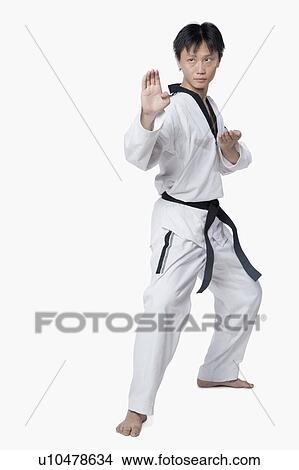 Picture - Mid adult man in fighting stance. Fotosearch