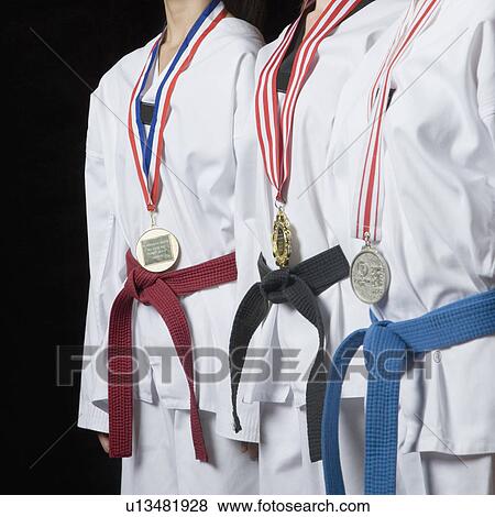 Mid section view of three people standing with their medals View Large Photo Image Stock Photo - Mid section view of three people standing with their medals. Fotosearch