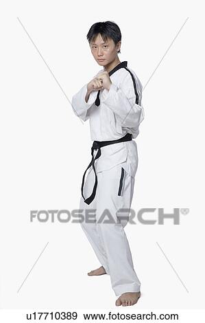 Portrait of a mid adult man in fighting stance View Large Photo Image Stock Photo - Portrait of a mid adult man in fighting stance. Fotosearch