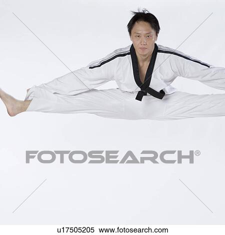 Portrait of a mid adult man jumping and practicing martial arts View Large Photo Image Stock Photography - Portrait of a mid adult man jumping and practicing martial arts. Fotosearch