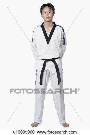 Portrait of a mid adult man standing with his hands behind his back View Large Photo Image Stock Image - Portrait of a mid adult man standing with his hands behind his back. Fotosearch