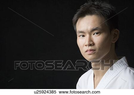 Portrait of a young man looking confident View Large Photo Image Stock Photography - Portrait of a young man looking confident. Fotosearch