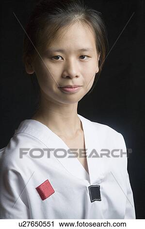 Stock Image - Portrait of a young woman looking confident. Fotosearch