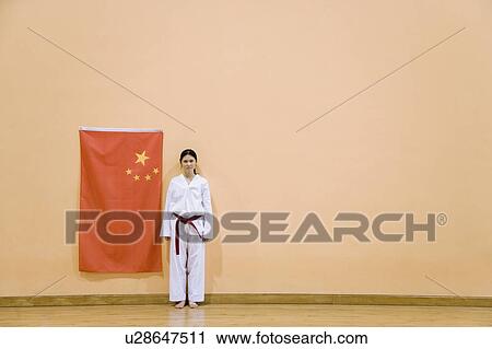 Portrait of a young woman standing near a Chinese flag View Large Photo Image Stock Image - Portrait of a young woman standing near a Chinese flag. Fotosearch