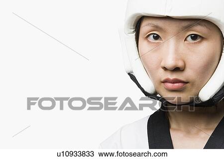 Stock Image - Portrait of a young woman wearing a sports helmet. Fotosearch