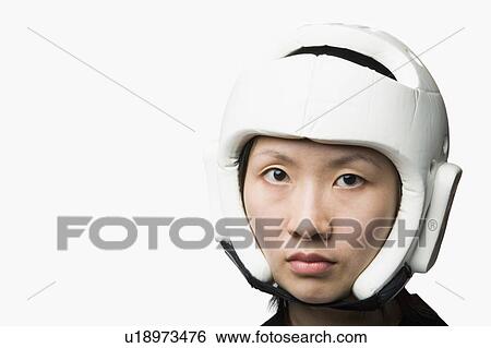 Stock Photograph - Portrait of a young woman wearing a sports helmet. Fotosearch
