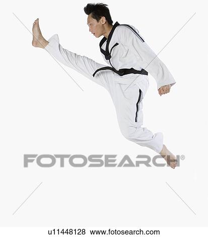 Side profile of a mid adult man jumping and practicing martial arts View Large Photo Image Stock Photo - Side profile of a mid adult man jumping and practicing martial arts. Fotosearch