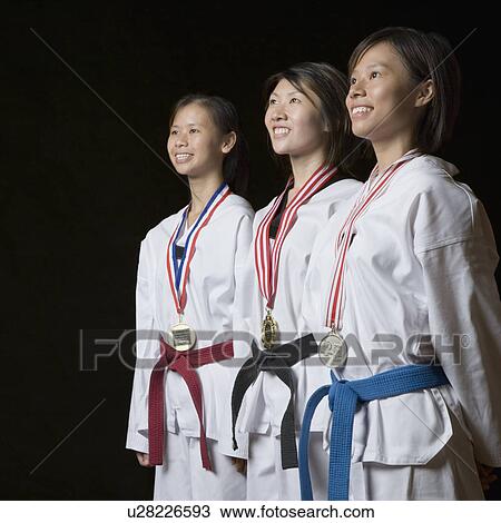 Three young women standing with their medals and smiling View Large Photo Image Stock Image - Three young women standing with their medals and smiling. Fotosearch