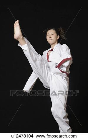 Young woman performing front kick View Large Photo Image Picture - Young woman performing front kick. Fotosearch
