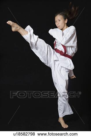 Young woman performing round kick View Large Photo Image Stock Photo - Young woman performing round kick. Fotosearch