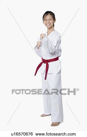 Stock Photograph - Young woman practicing karate and smiling. Fotosearch