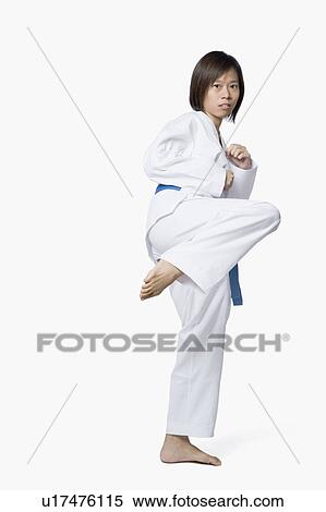 Stock Photography - Young woman practicing karate. Fotosearch