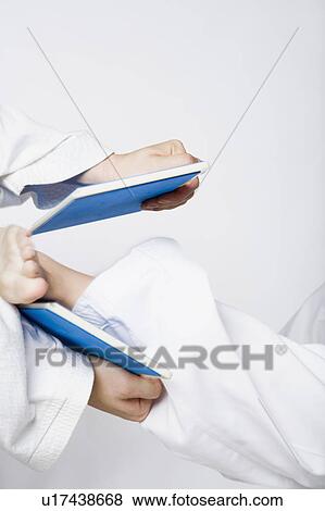 Close-up of a person's leg breaking a tile View Large Photo Image Stock Photo - Close-up of a person's leg breaking a tile. Fotosearch
