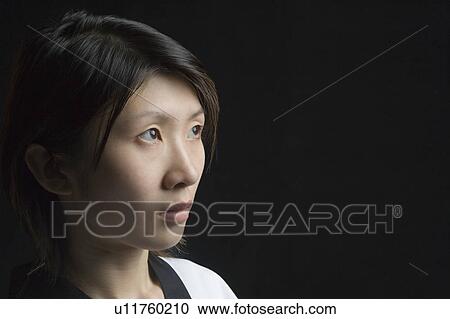 Stock Image - Close-up of a young woman contemplating. Fotosearch