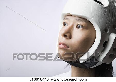 Close-up of a young woman wearing a sports helmet View Large Photo Image Stock Image - Close-up of a young woman wearing a sports helmet. Fotosearch