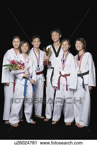 Group of martial arts players standing with their medals and trophies View Large Photo Image Stock Image - Group of martial arts players standing with their medals and trophies. Fotosearch