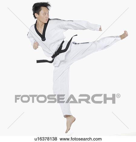 Mid adult man performing round kick View Large Photo Image Stock Photo - Mid adult man performing round kick. Fotosearch