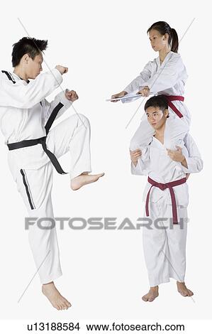 Mid adult man practicing kickboxing with a young man and a young woman View Large Photo Image Picture - Mid adult man practicing kickboxing with a young man and a young woman. Fotosearch