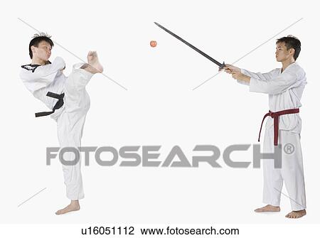 Mid adult man practicing martial arts with a young man View Large Photo Image Stock Image - Mid adult man practicing martial arts with a young man. Fotosearch