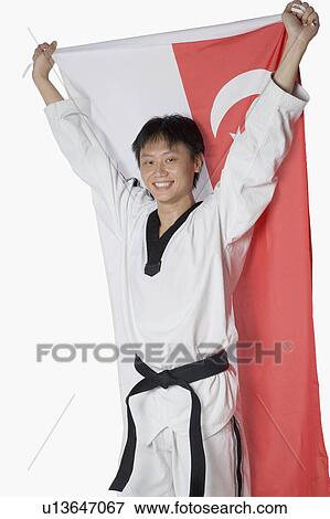 Stock Photo - Portrait of a mid adult man holding a Chinese flag. Fotosearch