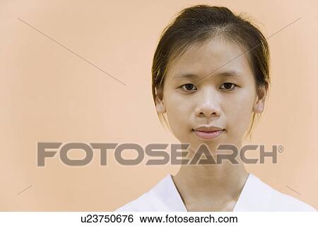 Stock Photograph - Portrait of a young woman looking serious. Fotosearch