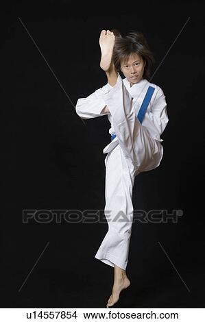 Portrait of a young woman performing front kick View Large Photo Image Picture - Portrait of a young woman performing front kick. Fotosearch