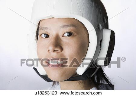 Stock Photo - Portrait of a young woman wearing a sports helmet and smiling. Fotosearch