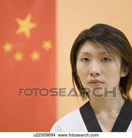 Picture - Portrait of a young woman with a Chinese flag in the background. Fotosearch