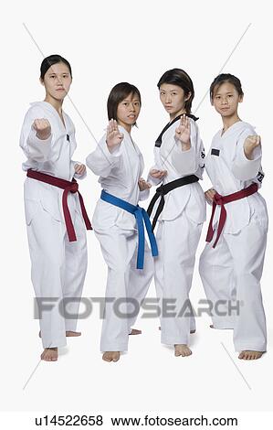 Stock Photo - Portrait of four young women in fighting stance. Fotosearch