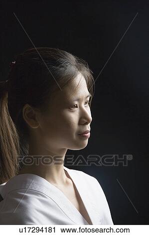 Side profile of a young woman contemplating View Large Photo Image Stock Image - Side profile of a young woman contemplating. Fotosearch
