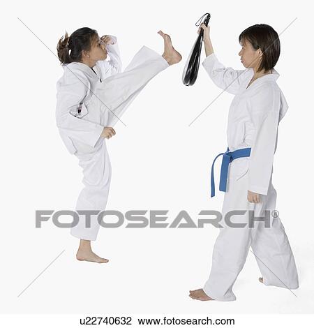 Side profile of two young women practicing karate View Large Photo Image Stock Image - Side profile of two young women practicing karate. Fotosearch