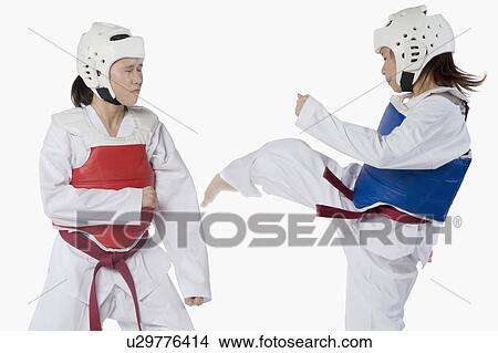 Picture - Two taekwondo players fighting. Fotosearch