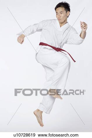Young man in kicking position View Large Photo Image Stock Photo - Young man in kicking position. Fotosearch