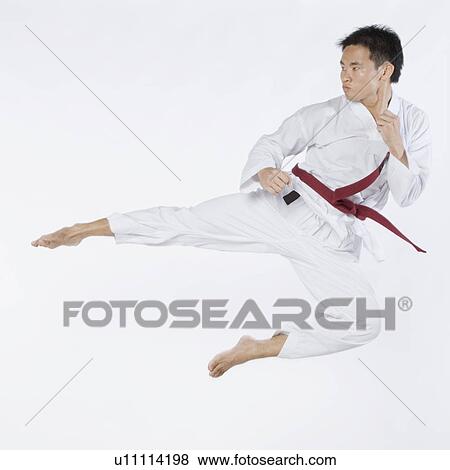 Young man performing flying kick View Large Photo Image Stock Photo - Young man performing flying kick. Fotosearch
