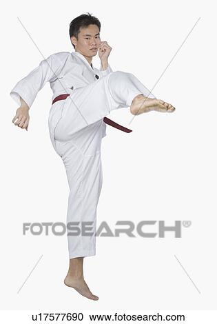 Young man performing side kick View Large Photo Image Stock Image - Young man performing side kick. Fotosearch