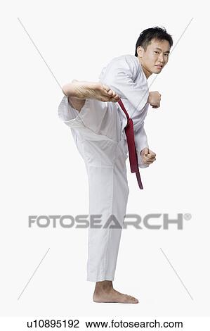 Young man practicing side kick View Large Photo Image Stock Image - Young man practicing side kick. Fotosearch