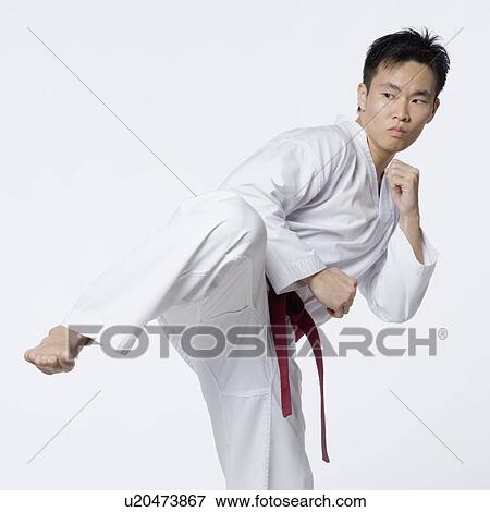 Young man practicing side kick View Large Photo Image Stock Photo - Young man practicing side kick. Fotosearch