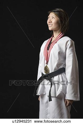Young woman standing with a medal around her neck View Large Photo Image Stock Image - Young woman standing with a medal around her neck. Fotosearch