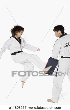 Stock Photo - Female karate instructor teaching martial arts to a young man. Fotosearch