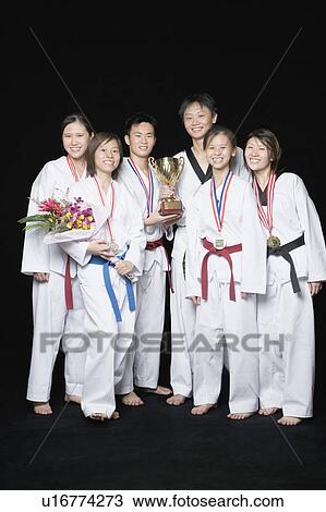Group of martial arts players standing with their medals and trophies View Large Photo Image Stock Image - Group of martial arts players standing with their medals and trophies. Fotosearch