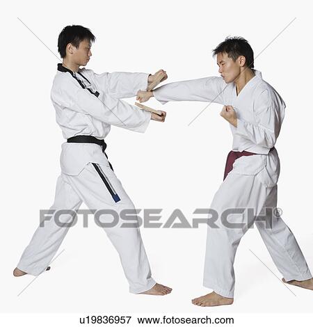 Male karate instructor teaching martial arts to a young man View Large Photo Image Stock Photo - Male karate instructor teaching martial arts to a young man. Fotosearch