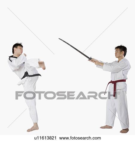 Mid adult man practicing martial arts with a young man View Large Photo Image Stock Image - Mid adult man practicing martial arts with a young man. Fotosearch