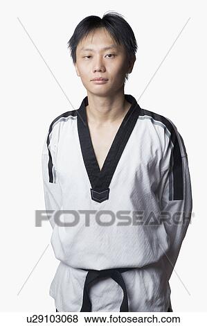 Portrait of a mid adult man standing with his hands behind his back View Large Photo Image Stock Photo - Portrait of a mid adult man standing with his hands behind his back. Fotosearch